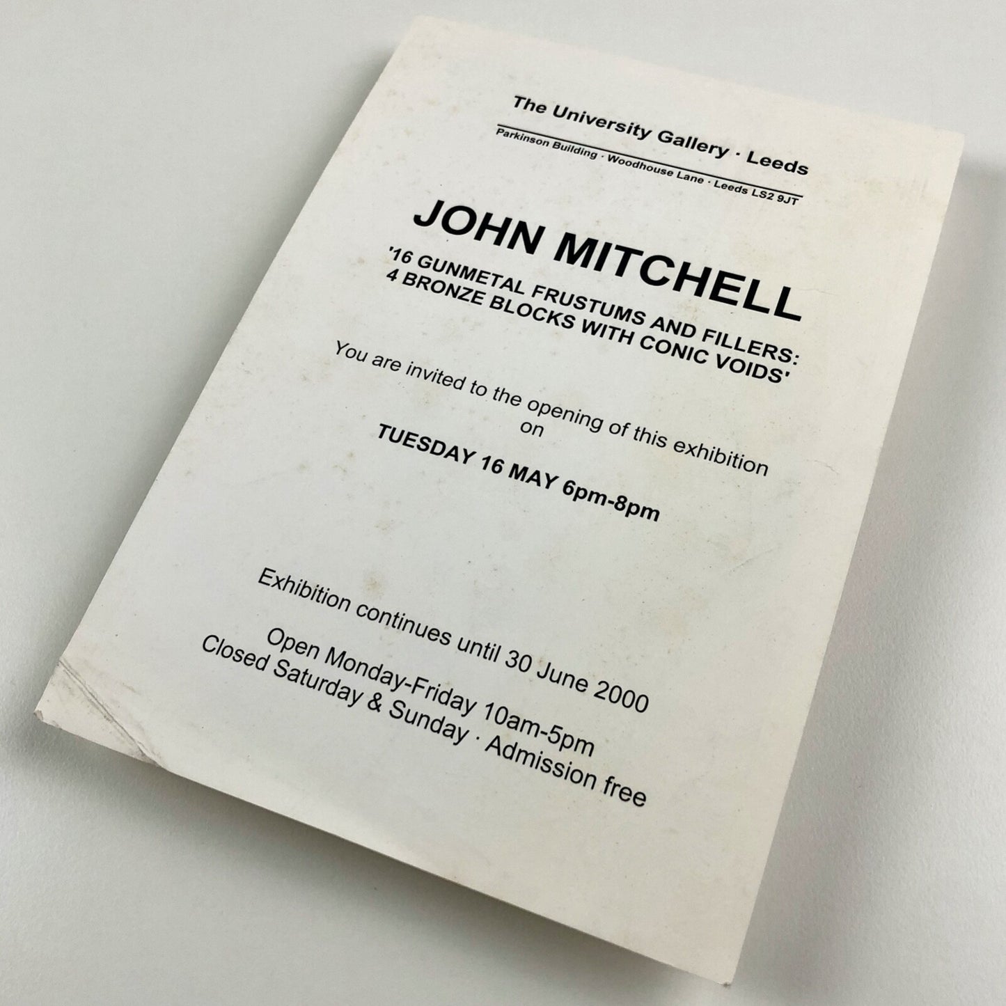 John Mitchell – 16 gunmetal frustums and filers: 4 bronze blocks with conic voids | The University Gallery Leeds | Private view card, 2000