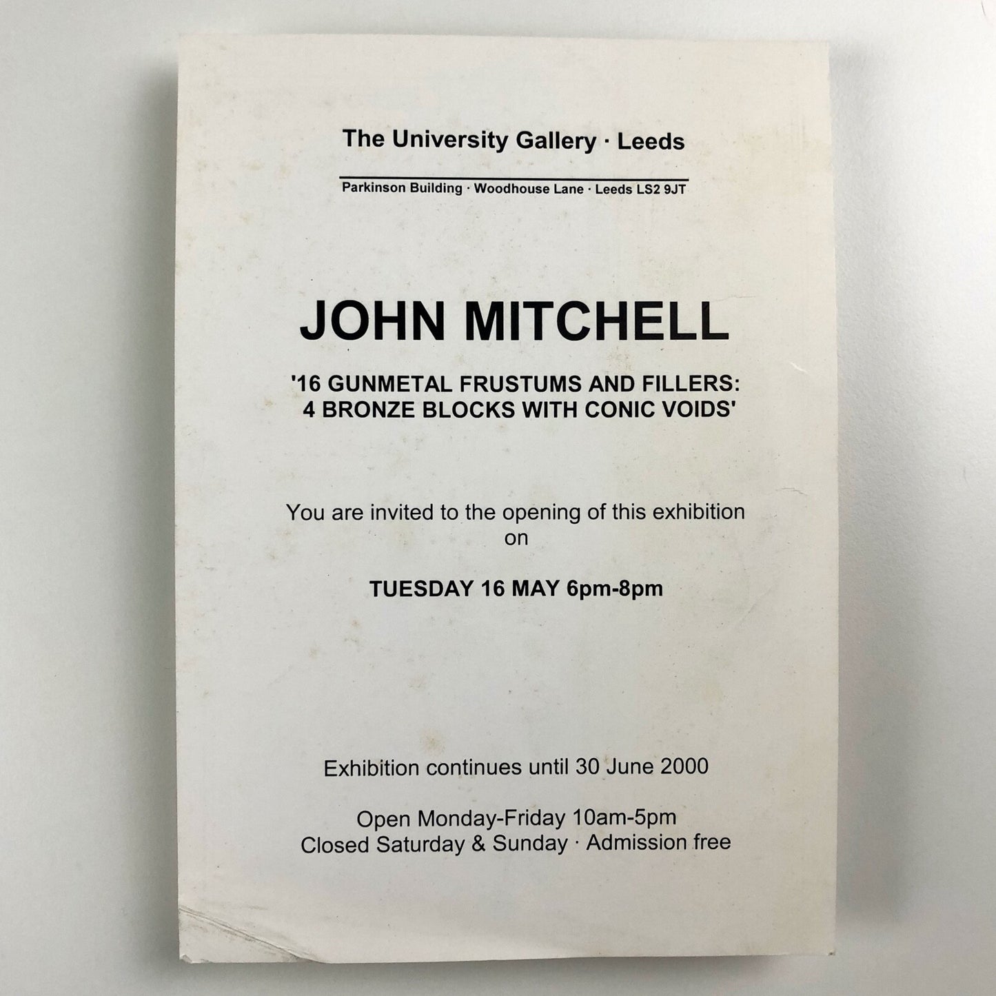 John Mitchell – 16 gunmetal frustums and filers: 4 bronze blocks with conic voids | The University Gallery Leeds | Private view card, 2000