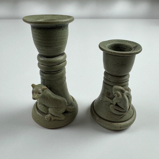 Pair of green earthenware frog and stoat candlesticks